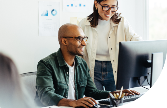 Hero background image - 2 people looking at computer monitor