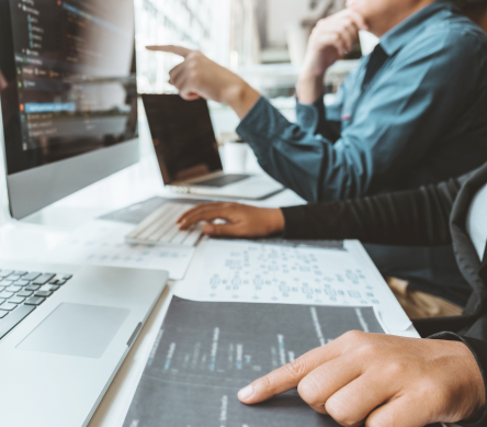 Close up of people working on code